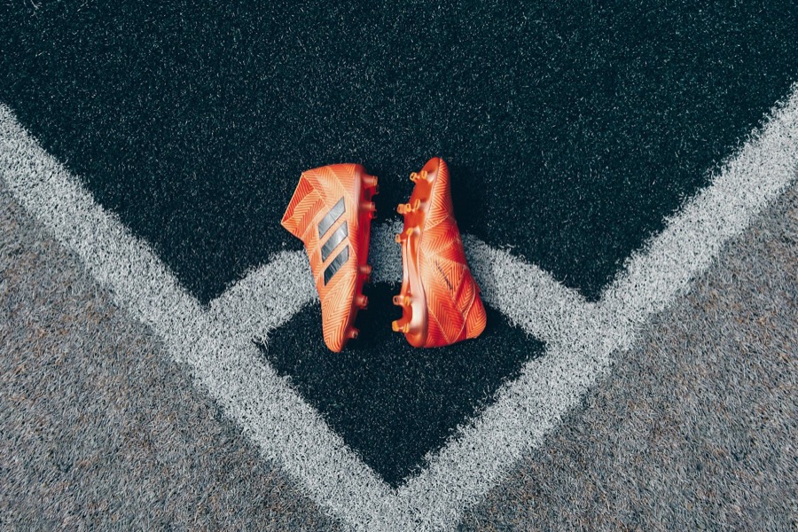 Football boots on the corner of a turf